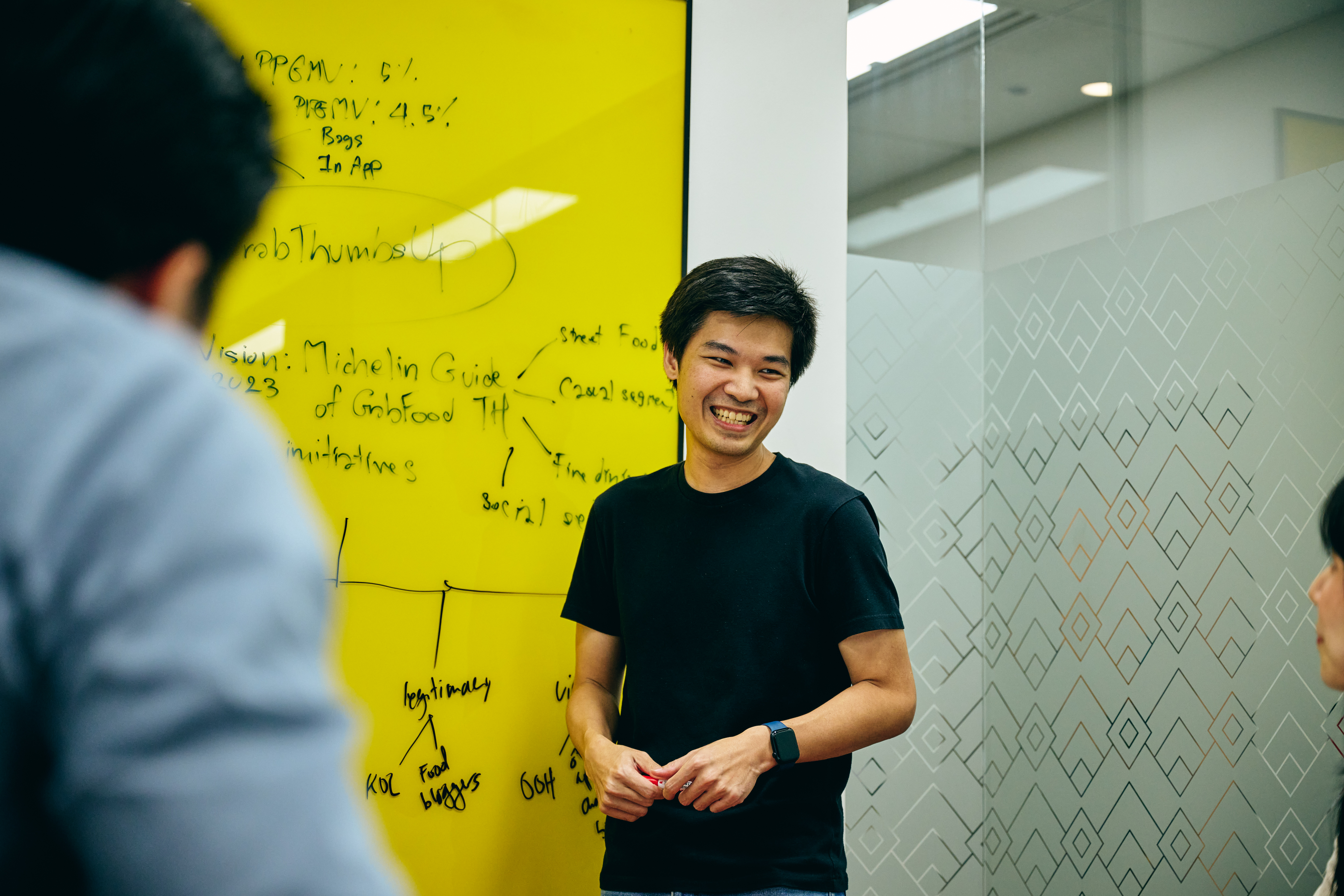 a person standing in front of a yellow board