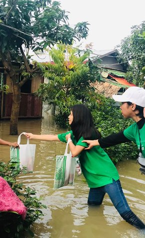 a group of people carrying shopping bags in a flooded area