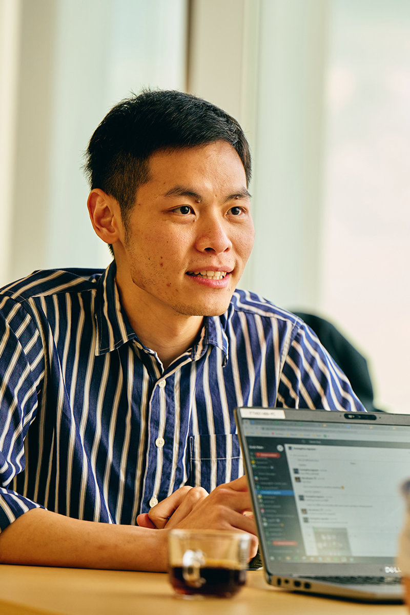 a man sitting at a table with a laptop