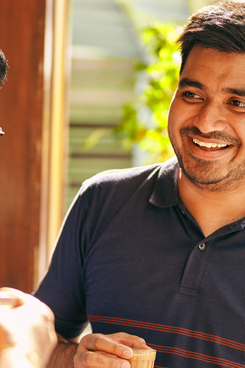 a group of men smiling and drinking