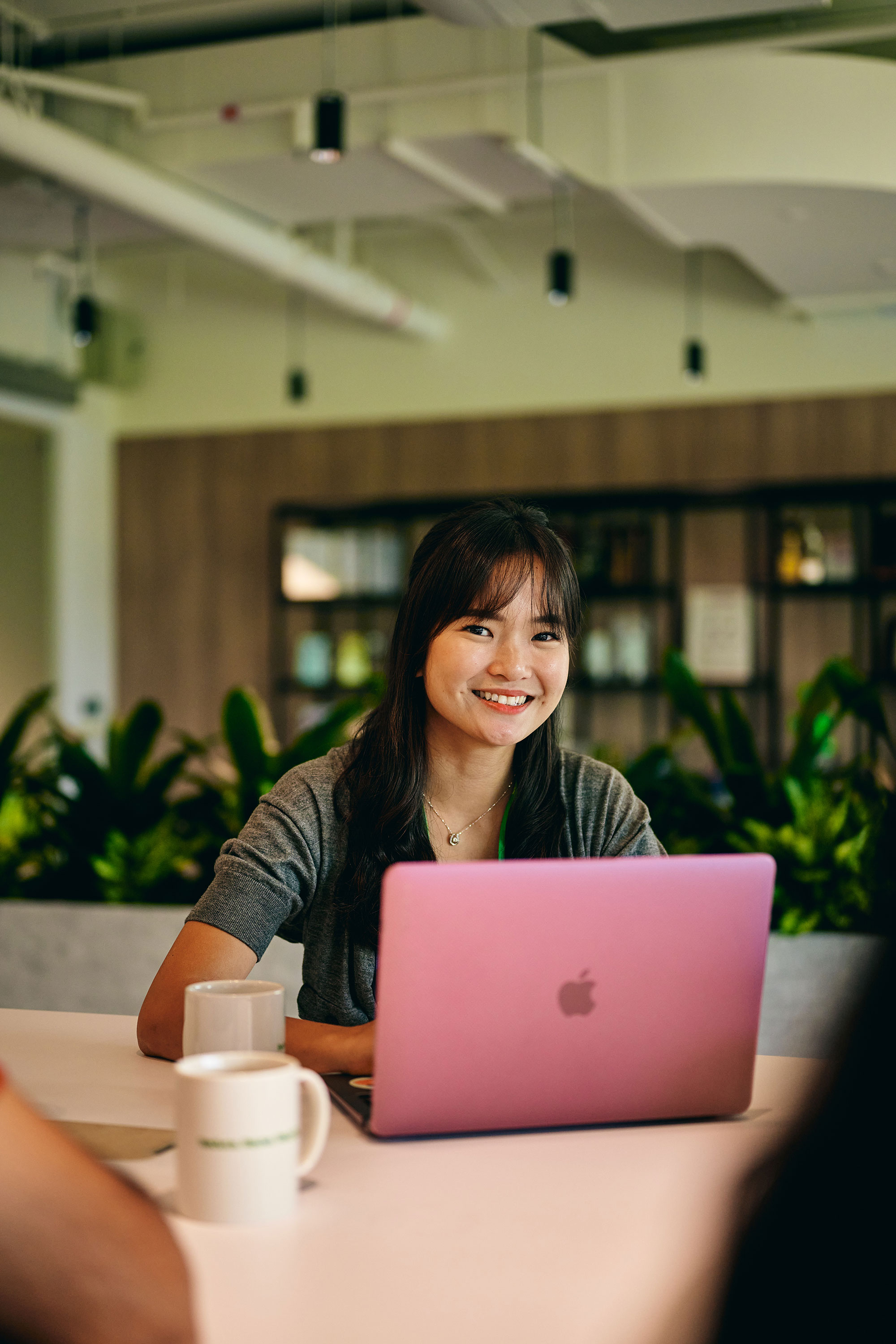 a woman sitting at a table with a laptop