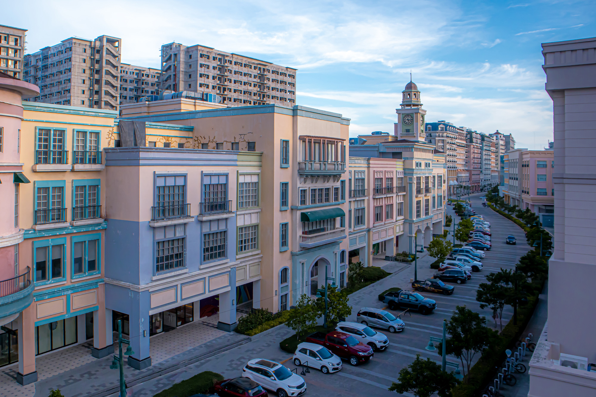 a parking lot with cars parked in front of a building