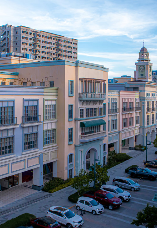 a parking lot with cars parked in front of a building