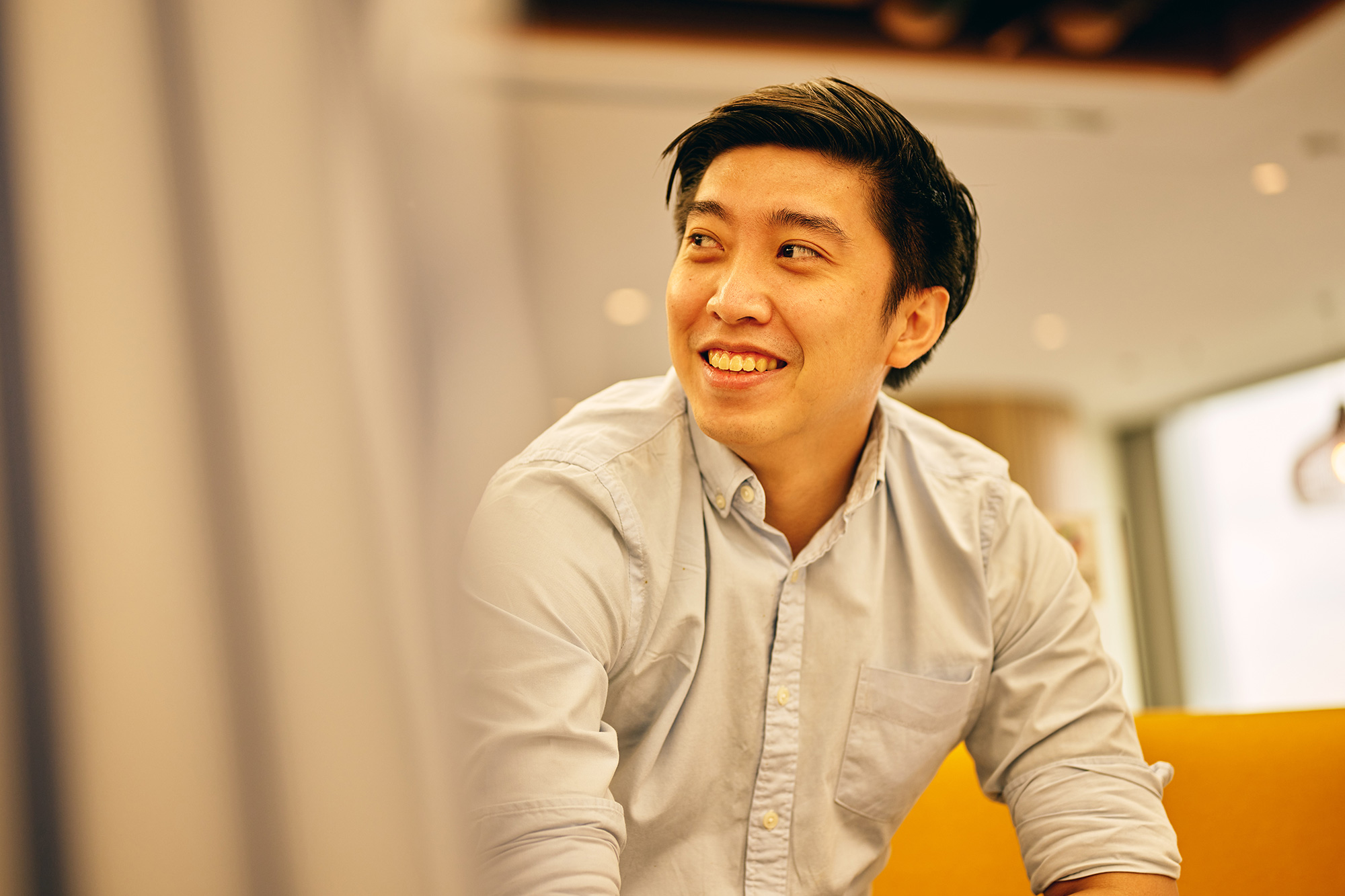 a man smiling and looking to the side