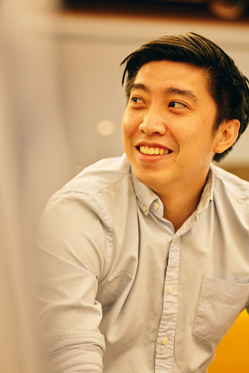 a man smiling and looking to the side