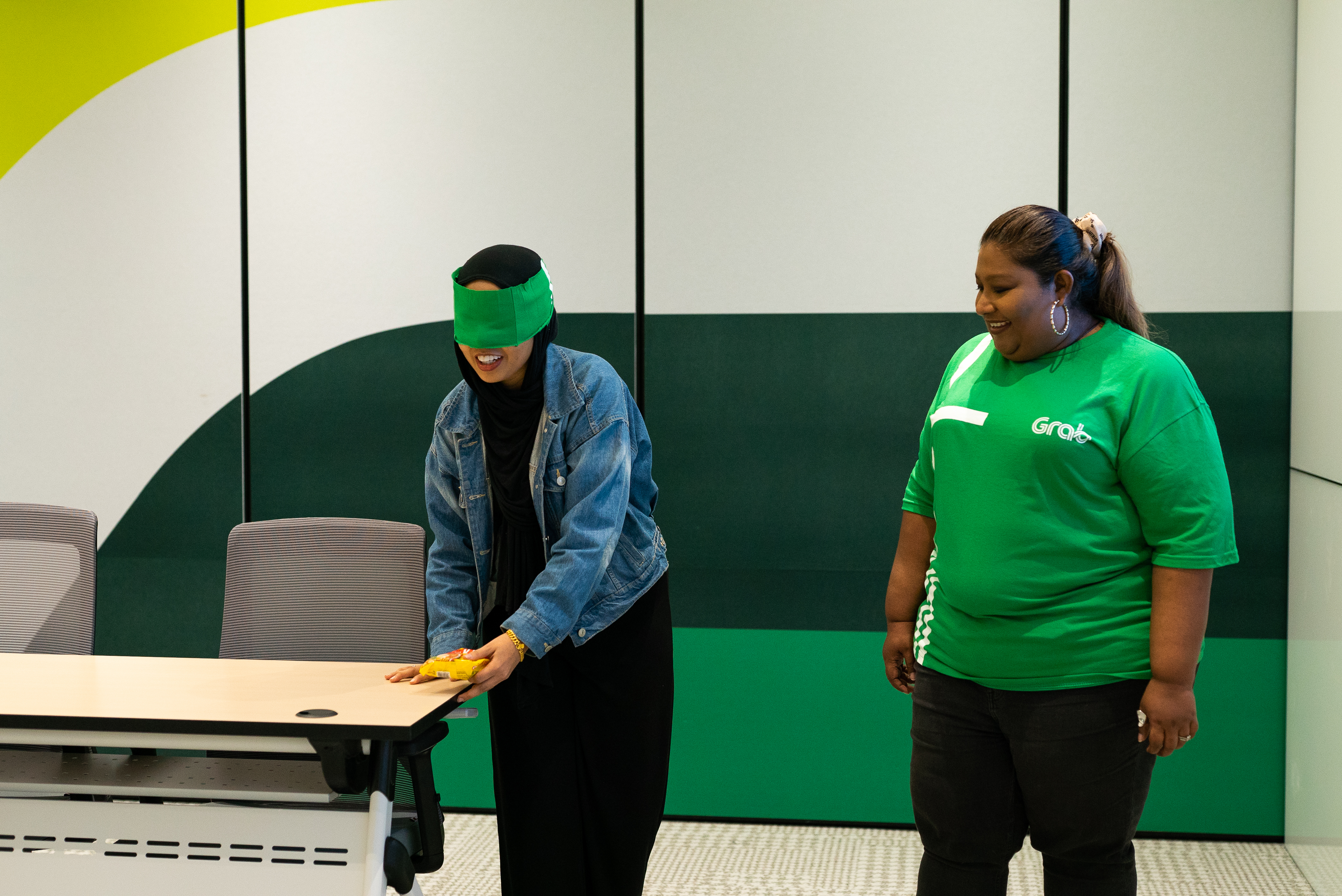 a person with blindfolded eyes standing next to a person