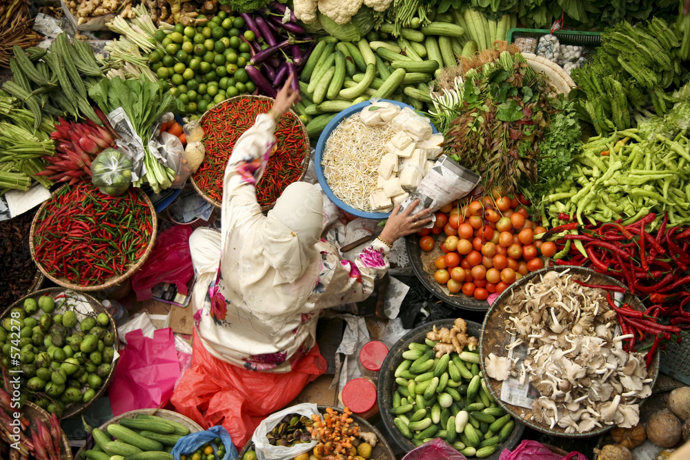 a woman in a white robe in a market
